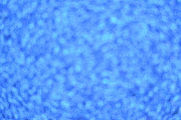 istock Winter festive shine sparkle glitter macro concept in blue color. Bokeh defocus disco effect. 1256628970