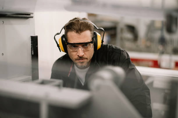 istock Young handsome factory worker. 1256629291