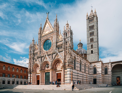 Siena Cathedral, Tuscany, Italy - Piazza del Duomo in Siena city. Some clouds in the sky.