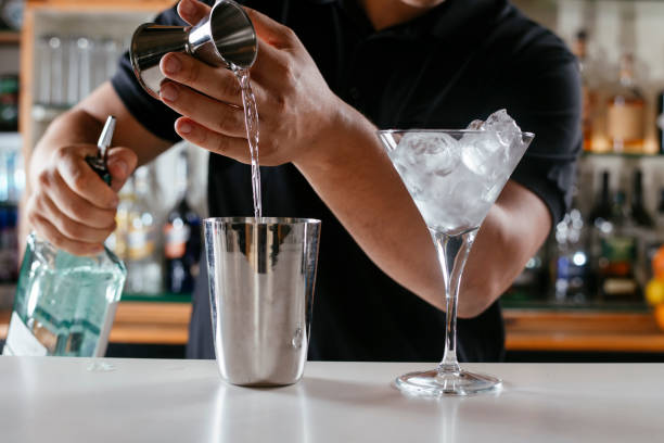 istock Expert barman making cocktail at nightclub. 1256633723