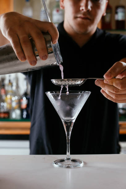 istock Expert barman making cocktail at nightclub. 1256633737