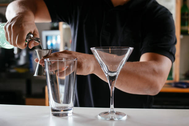 istock Expert barman making cocktail at nightclub. 1256633794