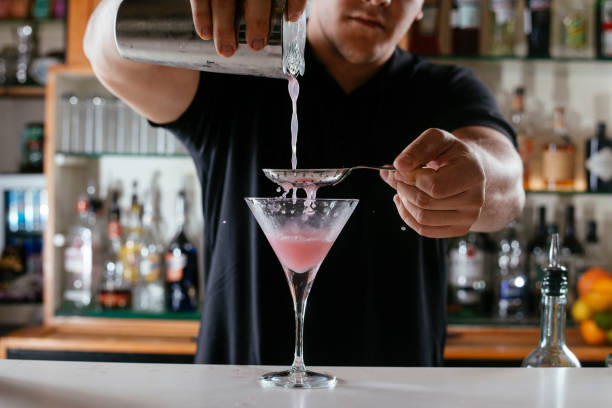 istock Expert barman making cocktail at nightclub. 1256633810