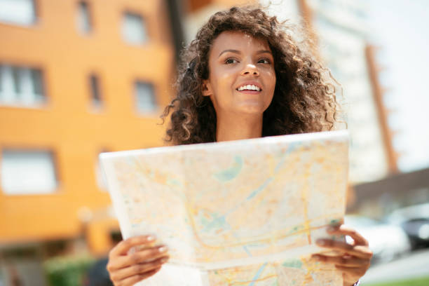istock Young african female traveler with map 1256635369