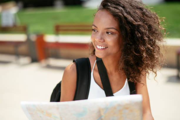istock Young african female traveler with map 1256635404