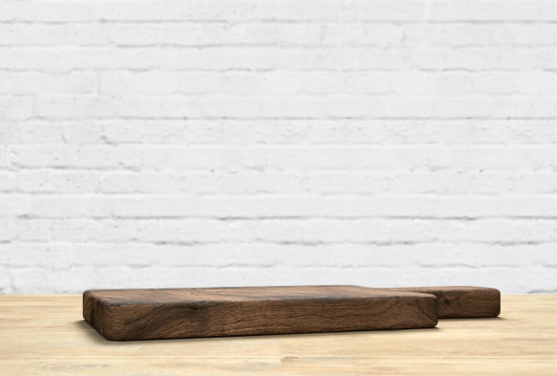 istock wooden table top with cutting board in front of blurred kitchen 1256635440