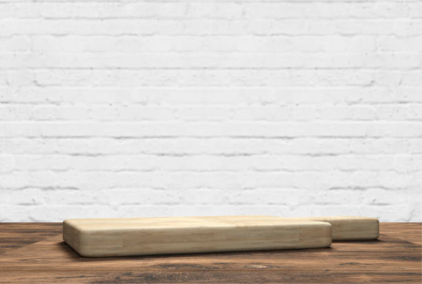 istock wooden table top with cutting board in front of blurred kitchen 1256635484