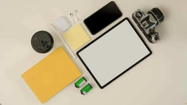 istock Digital devices on worktable with mock up tablet, smartphone, camera and stationery 1256635983