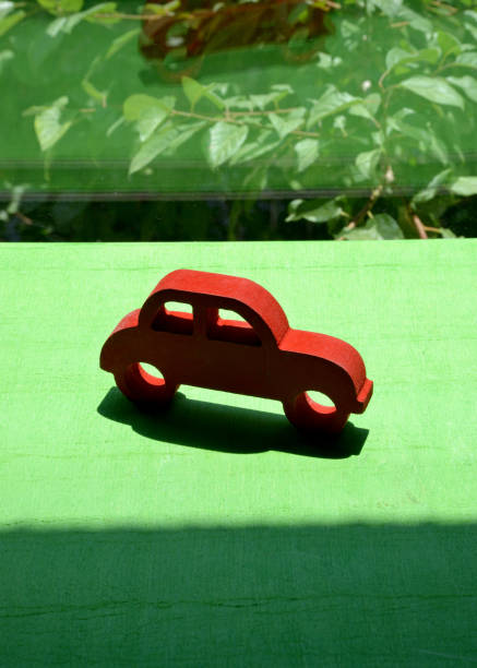 istock red toy car on the green grass 1256637009