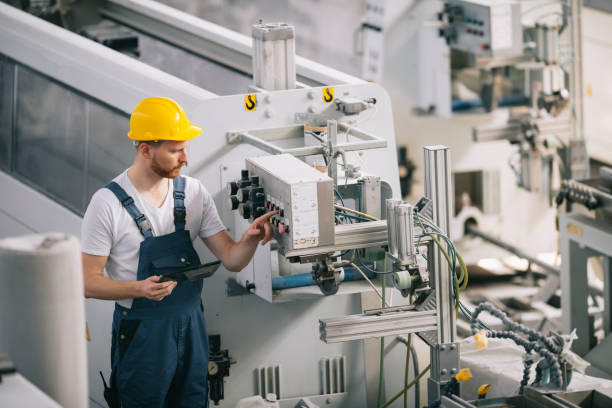 istock Young man with helmet working in factory. 1256637398
