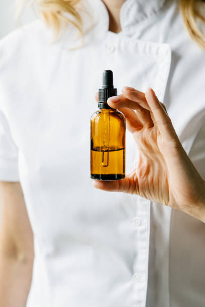 istock Cosmetologist holding cosmetic product. 1256637553