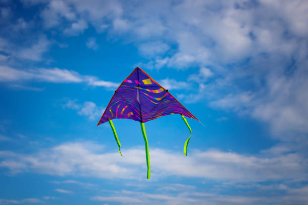 istock Kite flying in the sky among the clouds 1256638098