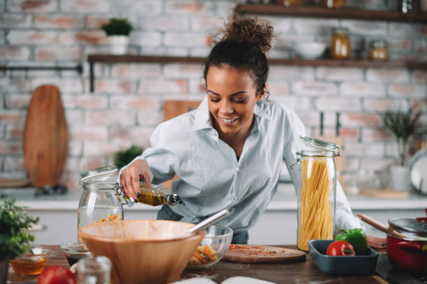 istock Beautiful woman having fun while cooking at home. 1256638436