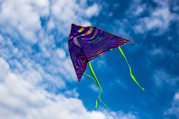 istock Kite flying in the sky among the clouds 1256638476