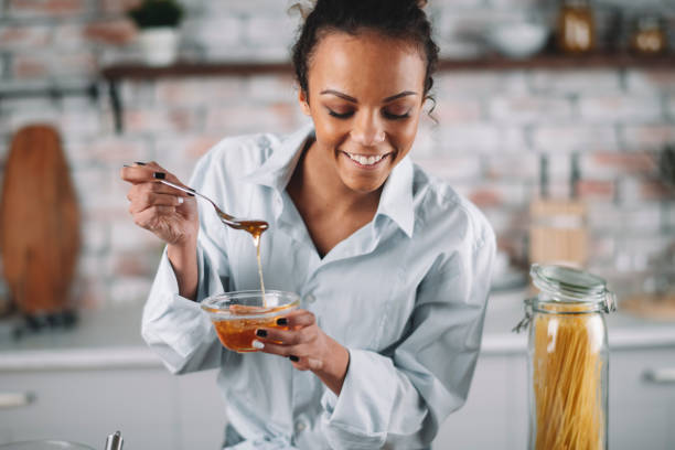 istock Beautiful woman having fun while cooking at home. 1256638482