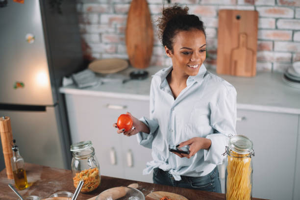 istock Beautiful woman having fun while cooking at home. 1256638488