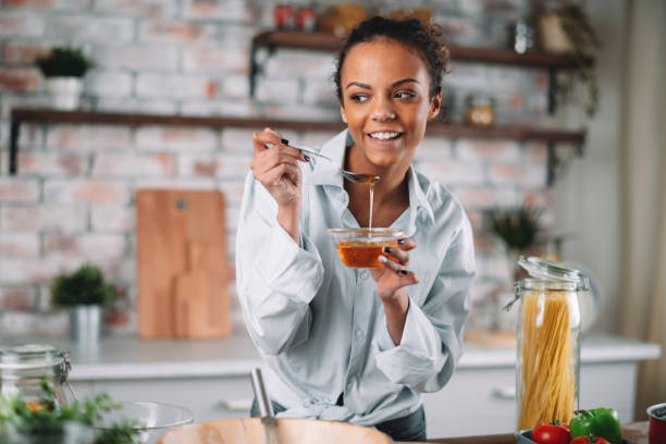 istock Beautiful woman having fun while cooking at home. 1256638505