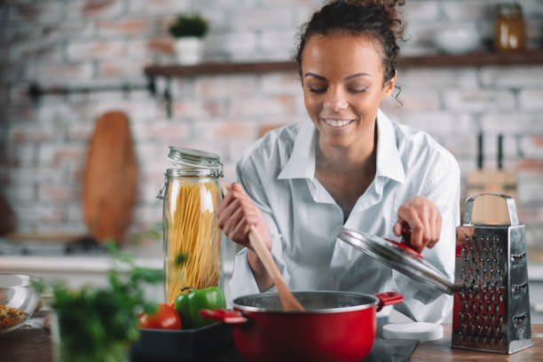 istock Beautiful woman having fun while cooking at home. 1256638526