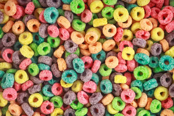 Background of round colorful cereal. Colorful breakfast food. Colorful cereal loop rings.