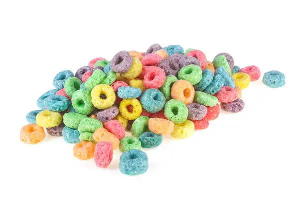 Pile of sweetened corn cereals isolated on a white background. Colorful corn rings.