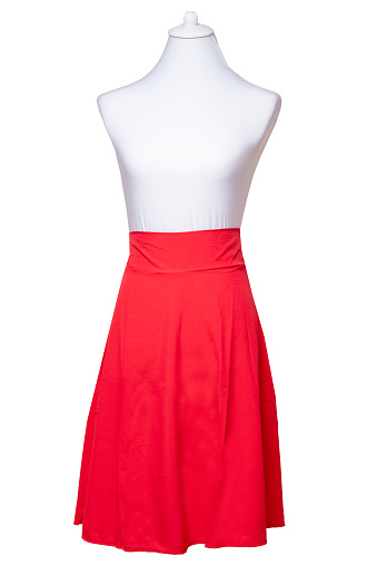 Woman clothes isolated. Closeup of elegant beautiful red summer skirt on a mannequin isolated on a white background. Womens red fashion.