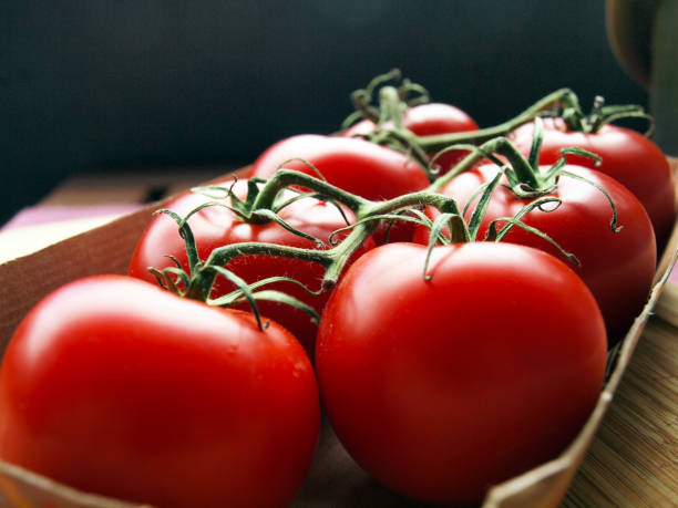 istock Fresh organic  tomatoes shot on rustic wooden table 1256639859