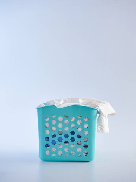 istock Basket with dirty clothes on white background 1256641385