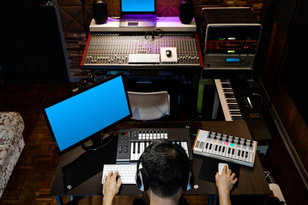 istock back of asian producer, sound engineer working in recording, broadcasting studio 1256642859