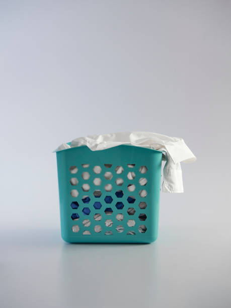 istock Basket with dirty clothes on white background 1256643607