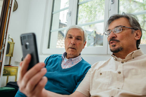 istock Male senior friends using cellphone 1256650538