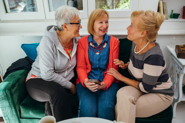 istock Female senior friends using cellphone 1256650551
