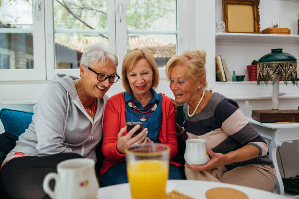 istock Female senior friends using cellphone 1256650554