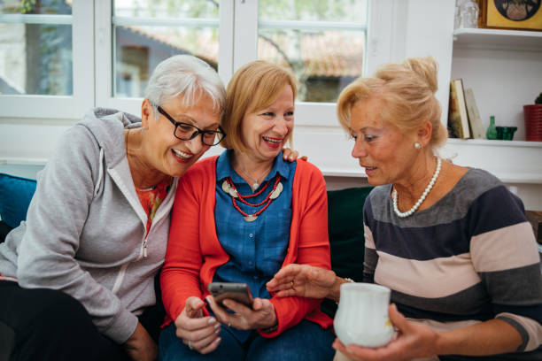 istock Female senior friends using cellphone 1256650584