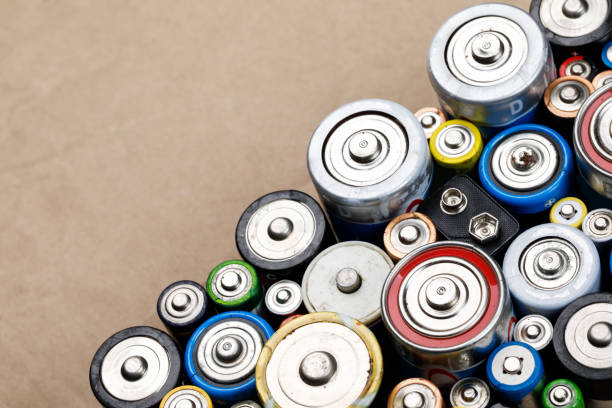 istock Used batteries toxic waste recycling and ecology issues concept background 1256650753