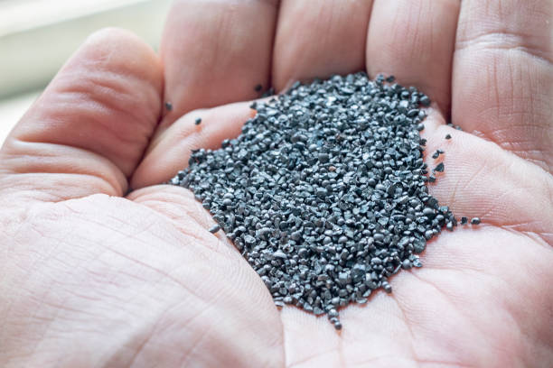 istock View of the angular steel grits in the palm for sandblasting or abrasive blasting. 1256651975