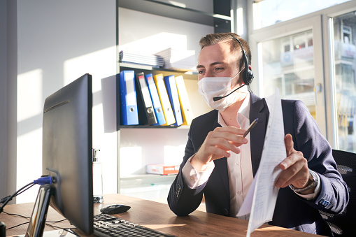 Telemarketer working avoiding covid-19 at office