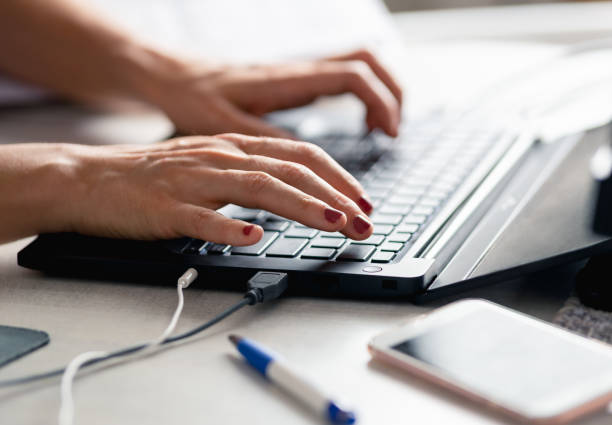istock Woman hands typing on laptop 1256653258