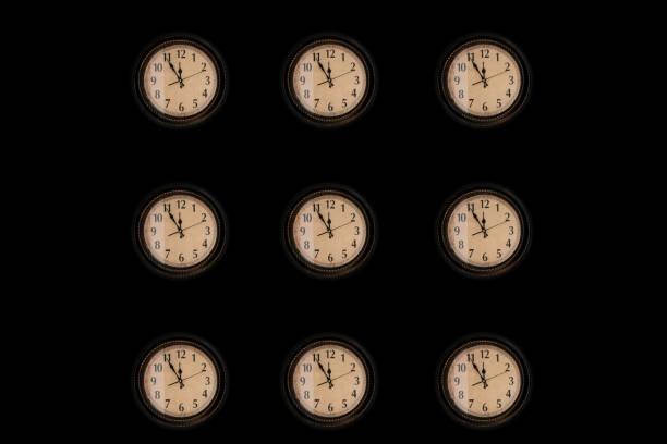 istock Pattern of vintage wall clocks hanging on black background. 1256653287
