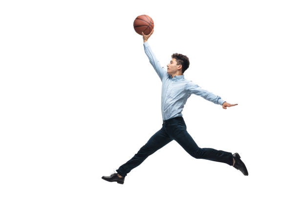 Man in office clothes playing basketball on white background. Unusual look for businessman in motion, action. Sport, healthy lifestyle. Achieves. Man in office clothes playing basketball on white background like professional player, sportsman. Unusual look for businessman in motion, action with ball. Sport, healthy lifestyle, creativity. unusual basket stock pictures, royalty-free photos & images