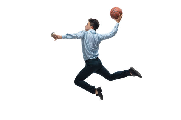 Man in office clothes playing basketball on white background. Unusual look for businessman in motion, action. Sport, healthy lifestyle. In jump. Man in office clothes playing basketball on white background like professional player, sportsman. Unusual look for businessman in motion, action with ball. Sport, healthy lifestyle, creativity. unusual basket stock pictures, royalty-free photos & images