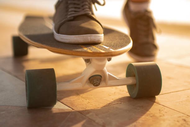 istock Young teen walking around with skateboard 1256656842