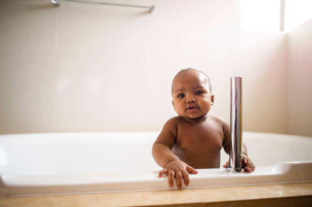 istock Boy in a bath tub looking at camera 1256664481