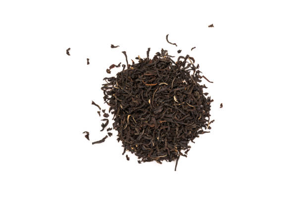 istock Fragrant Leaves of black premium dry tea on a white background 1256664584