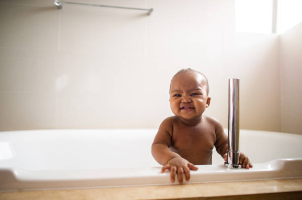 istock Boy in a bath tub smiling 1256664606