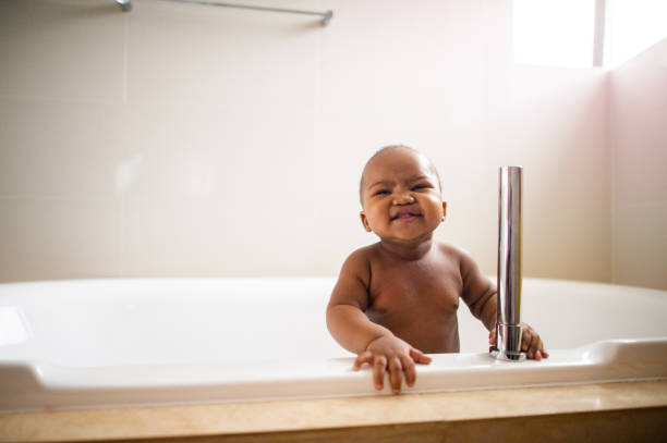 istock Boy in a bath tub smiling looking happy 1256664676