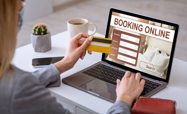 istock Businesswoman making online reservation, using laptop at workplace 1256667220