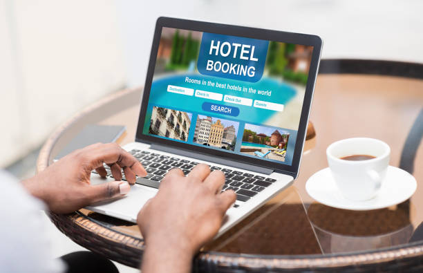 istock Black guy using laptop at cafe, looking for hotel online 1256667384
