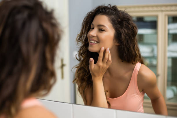 istock Woman looking herself in the mirror 1256667625