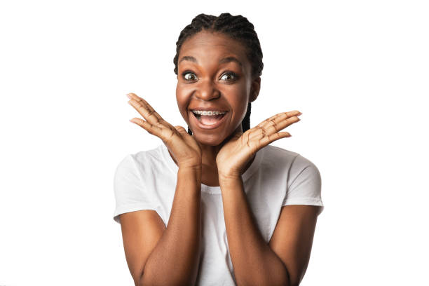 Excited African American Woman With Orthodontic Braces Shouting, Studio Shot Excited African American Woman With Orthodontic Braces Shouting Holding Hands Near Face Posing Over White Background. Excitement. Studio Shot beautiful women giving head stock pictures, royalty-free photos & images