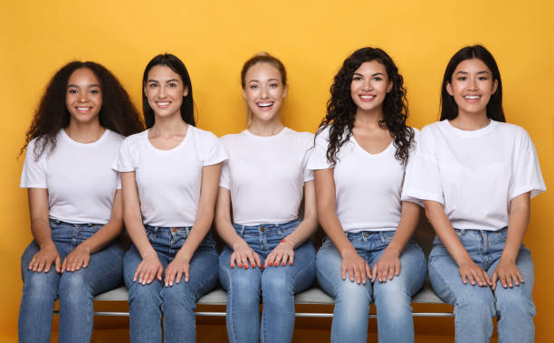 istock Happy Women Smiling To Camera Sitting On Bench, Studio Shot 1256669152
